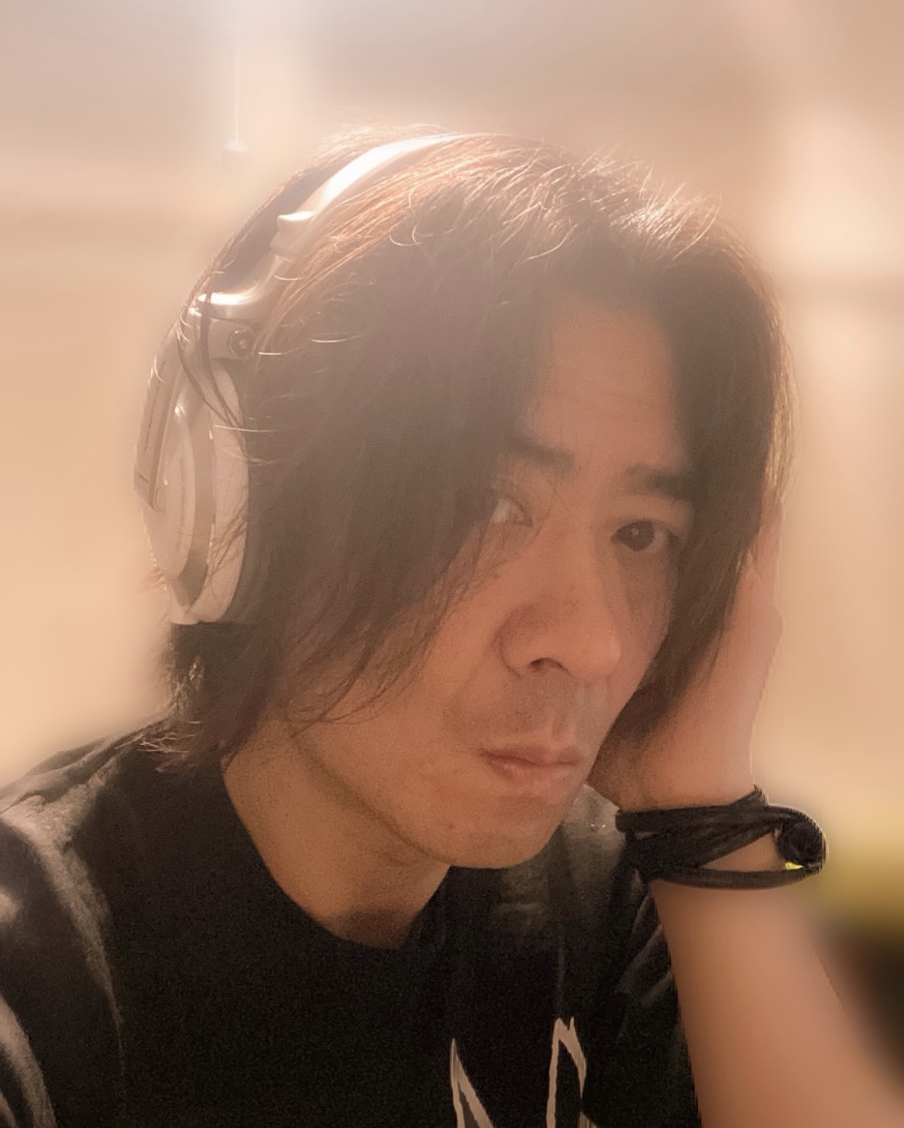 Junsaku wearing headphones
