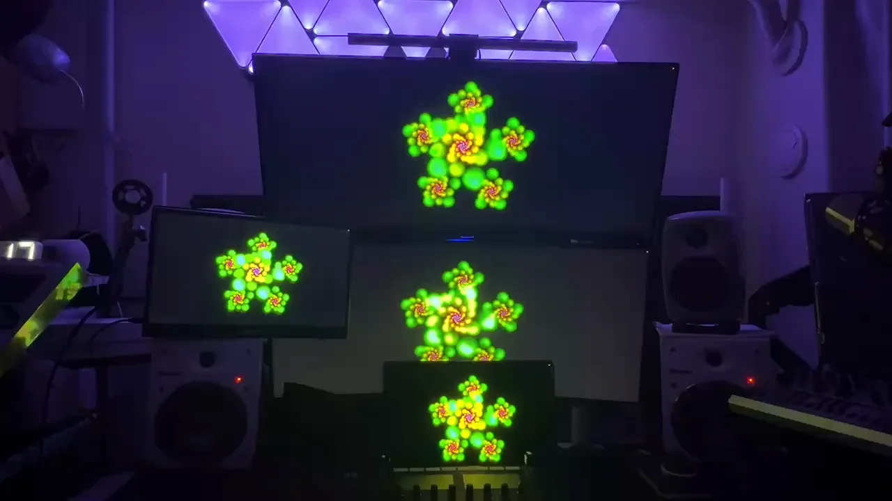 Four monitors glowing in Junsaku’s studio